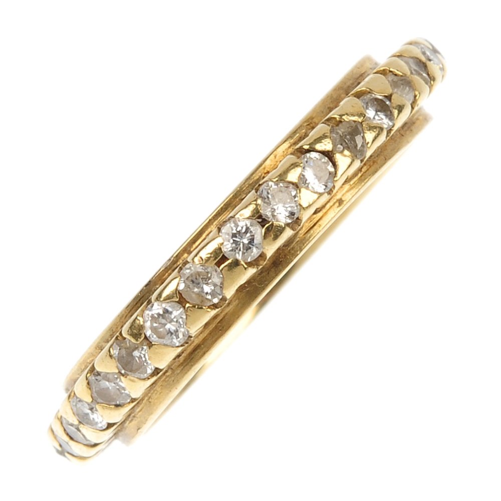 A diamond full-circle eternity ring.: A diamond full-circle eternity ring. The brilliant-cut diamond line, within a raised setting, to the plain band. Estimated total diamond weight 0.70ct. Ring size L. Weight 3.8gms.