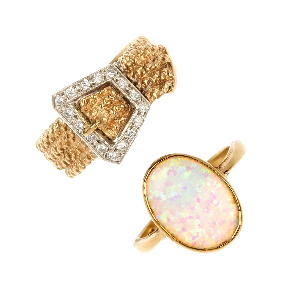 Two 9ct gold gem-set rings.: Two 9ct gold gem-set rings. To include a 9ct gold textured buckle ring with colourless paste detail and a 9ct gold oval synthetic opal cabochon ring. Hallmarks for Birmingham. Weight 10.1gms.