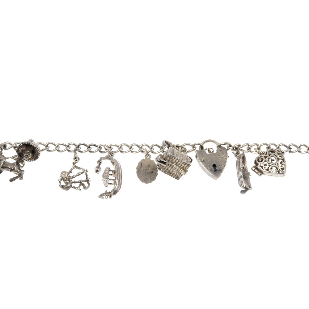 Two silver charm bracelets.: Two silver charm bracelets. Each designed as a curb-link bracelet, suspending a total of twenty-nine charms, including a football with trophy interior. Clasps with hallmarks for silver. Lengths 18.5 a