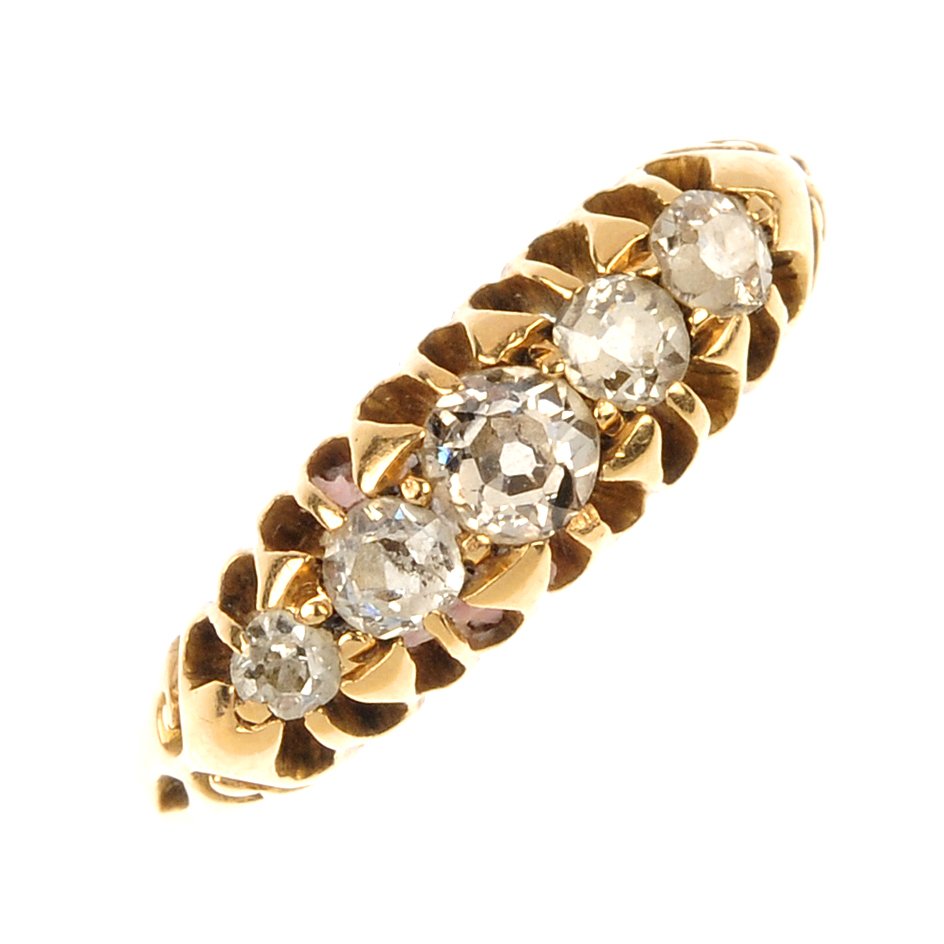 An Edwardian 18ct gold diamond five-stone ring.: An Edwardian 18ct gold diamond five-stone ring. The graduated old-cut diamond line, to the scrolling shoulders and plain band. Estimated total diamond weight 0.40ct. Hallmarks for Chester, 1906. Weigh