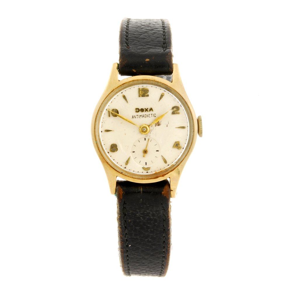 A 14k gold manual wind lady's Doxa wrist watch.: A 14k gold manual wind lady's Doxa wrist watch, the white dial having hourly applied gilt markers alternating with Arabic numerals, subsidiary seconds dial positioned to six o'clock, bordered by a min