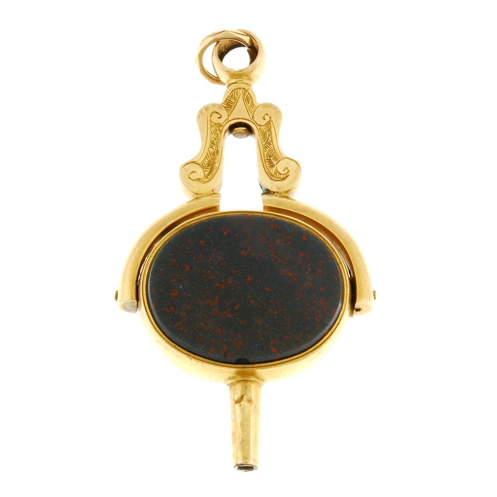 A stone-set watch fob.: A yellow metal swivel fob key, the bloodstone and chalcedony fob, surround stamped 10ct, scroll and foliate engraved surmount. Total weight 11gms.