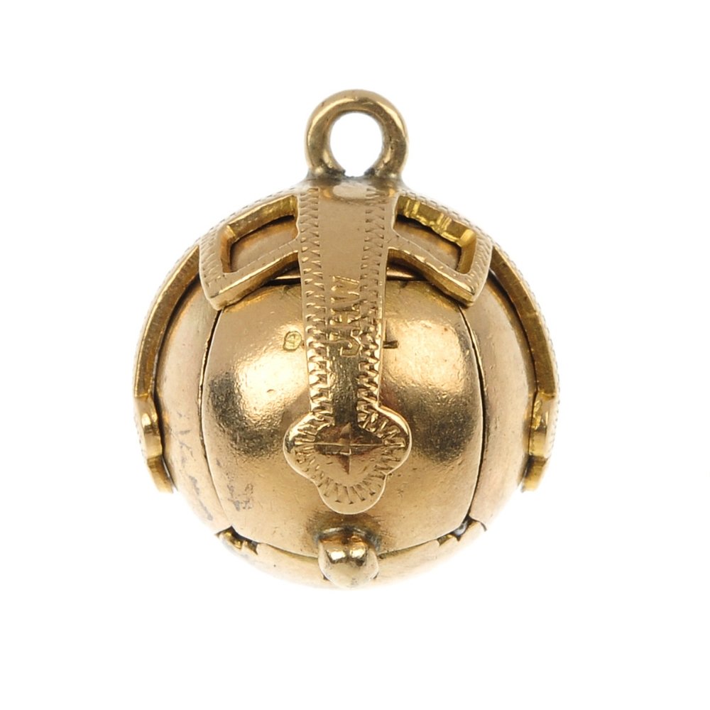 A Masonic ball pendant.: A Masonic ball pendant. The hinged sphere, unfurling to reveal a cross with engraved Masonic emblems. Diameter 1.6cms. Weight 7.7gms.