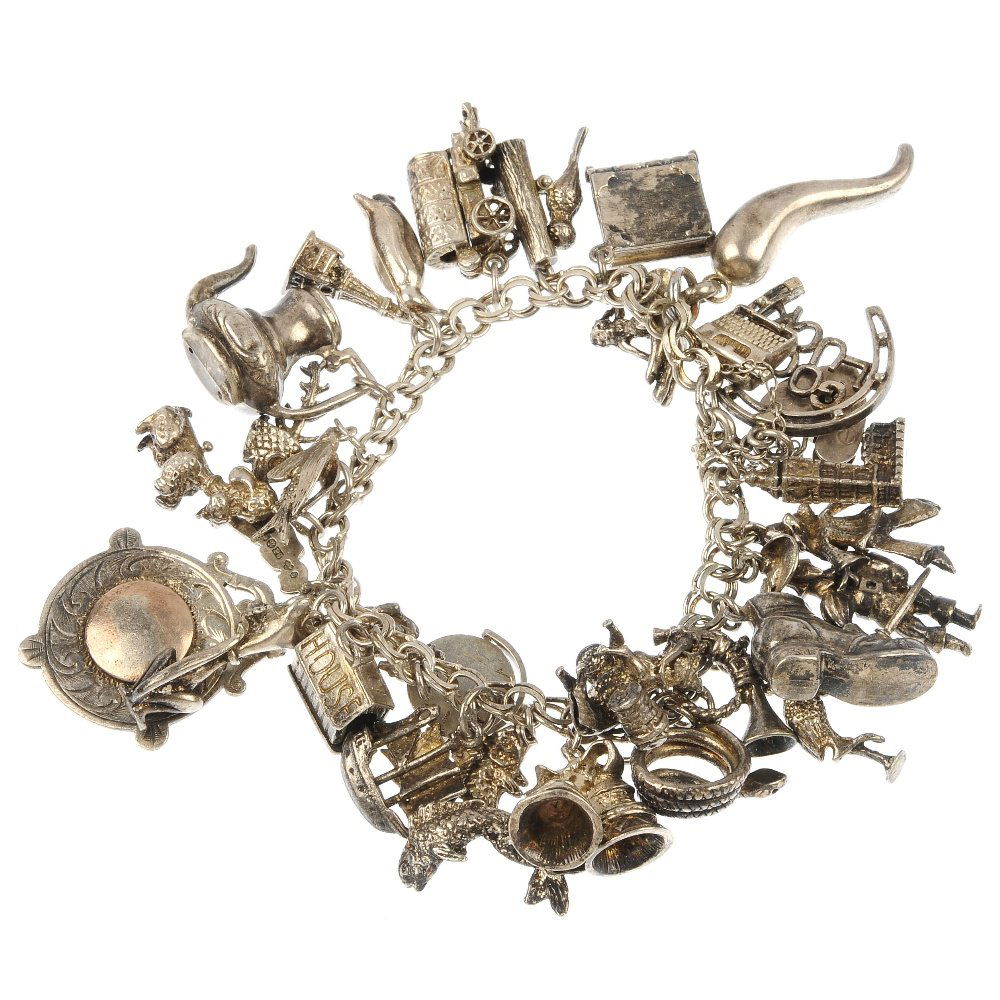 Two silver and white metal charm bracelets.: Two silver and white metal charm bracelets. To include a curb-link bracelet suspending eleven charms, together with a similar bracelet suspending twenty-nine charms. Hallmarks for London, 1978. Length