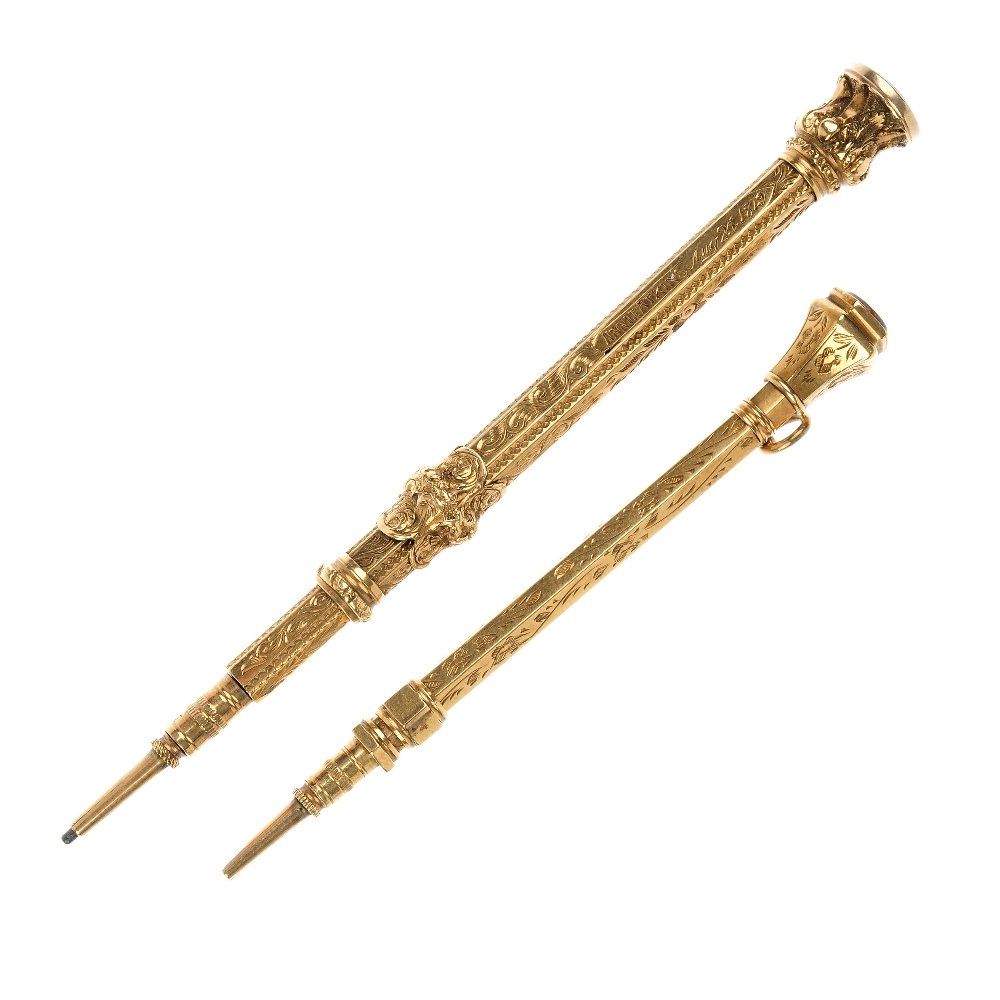 Two late 19th century pencils.: Two late 19th century pencils. Each of scrolling foliate engraved design and foil back gem terminal, one with scrolling push piece slider and personal inscription dated 1879. Lengths 9.2 and 7.3cms. T