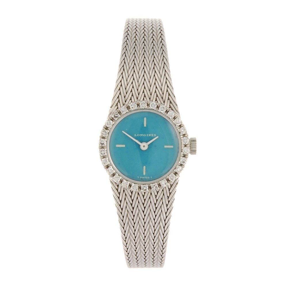 (532469-2-A) An 18k white gold manual wind lady's: (532469-2-A) LONGINES - an 18k white gold manual wind lady's bracelet watch, the turquoise dial with quarterly applied markers, white stone set bezel, round case stamped 18K 0.750, fitted to an integr