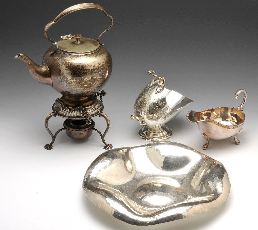 A selection of plated ware to include a tea service,: A selection of plated ware to include a three part tea service, a circular dish with repeated concave pattern and a hammered finish, a spirit kettle and stand, two coal scuttle style salts, etc.