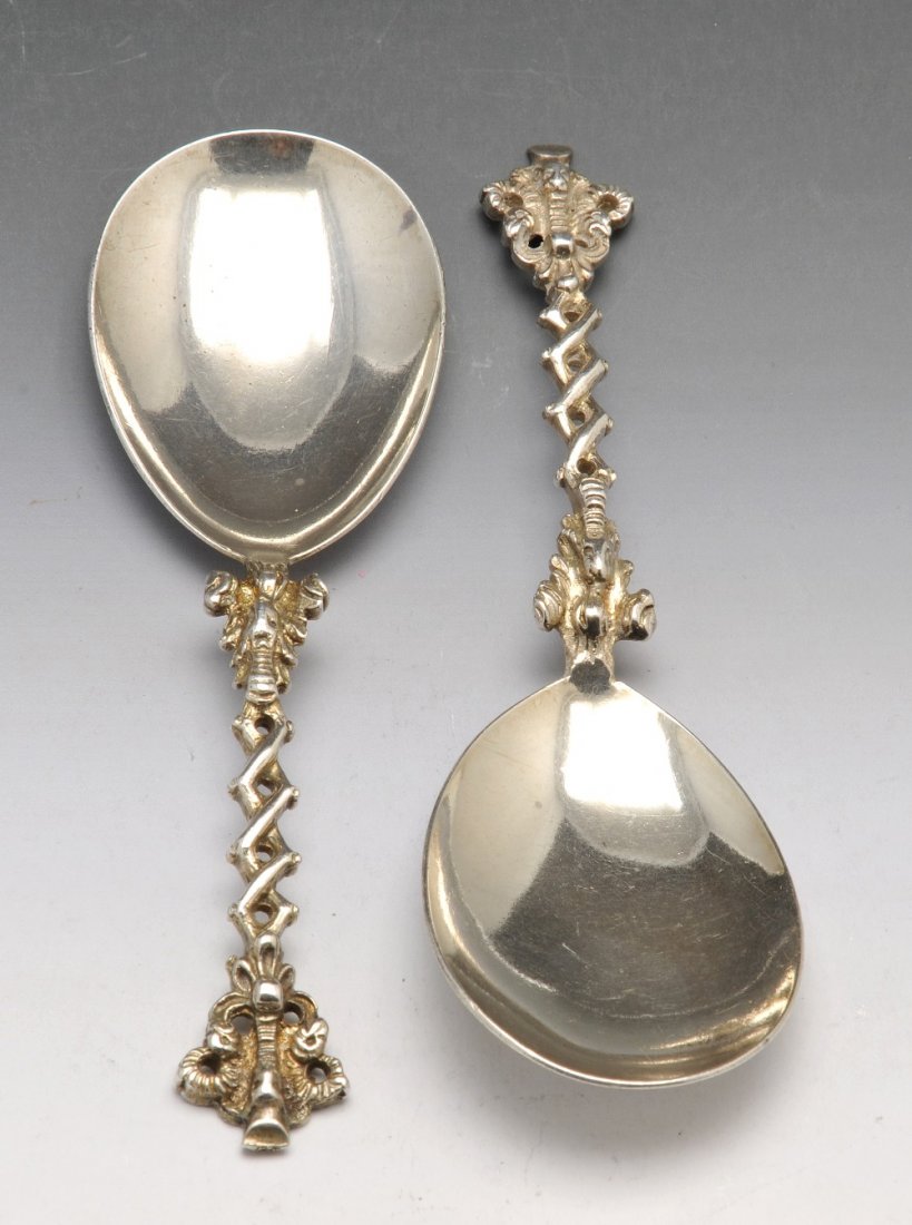 A Victorian pair of silver spoons.: A Victorian pair of silver spoons with plain teardrop shaped bowls and ornate short stems leading to rams head terminals, hallmarked Charles Stuart Harris, London 1880. Height 5 inches (12.75 cm), wei