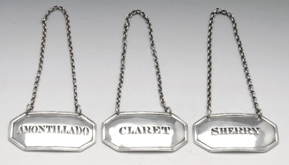 Three Victorian matching silver wine labels.: Three matching Victorian silver wine labels, pierced, for Amontillado, Claret and Sherry within oblong surround with canted corners and reeded rims. Hallmarked Charles Stuart Harris, London 1881. Gros