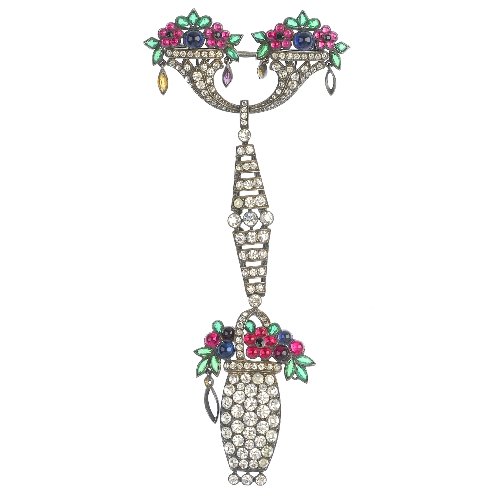 KNOLL & PREGIZER - an early 20th century silver paste: KNOLL & PREGIZER - an early 20th century silver paste floral brooch, designed as a vari-shade circular paste cabochon and vari-shape paste jardiniere, suspended from a colourless paste geometric link,