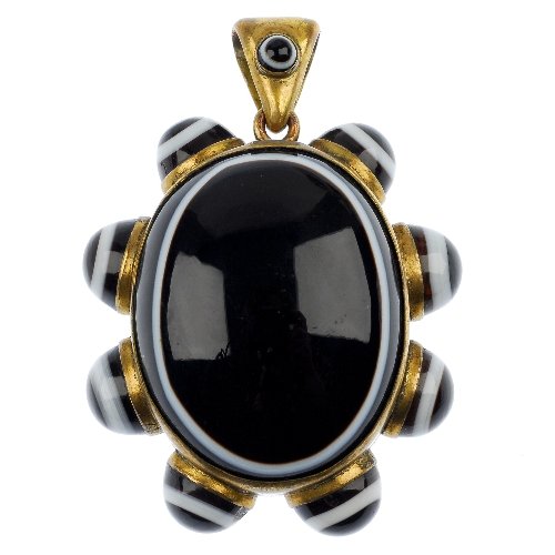 A late 19th century agate locket.: A late 19th century agate locket, the oval agate cabochon surrounded by eight circular agate cabochons to the reverse vacant panel. Length including suspension loop 6cms.