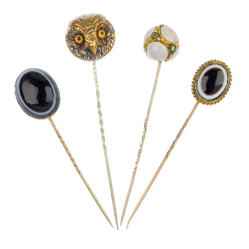 A selection of four stickpins.: A selection of four stickpins, to include two oval-shape banded agate stickpins, a chalcedony and turquoise orb stickpin and an owl head stickpin. Lengths 8.3 to 7.4cms.