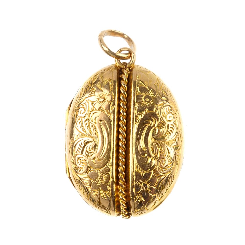 A late 19th century 18ct gold locket.: A late 19th century 18ct gold locket. Of oval-shape outline, the scroll engraved casing, with central rope-twist detail. Length 2.9cms. Weight 3.3gms.