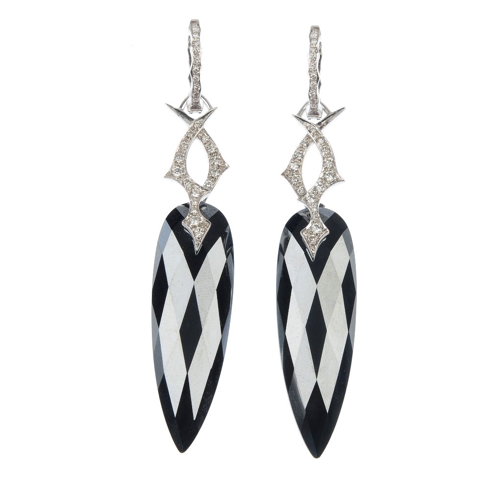 STEPHEN WEBSTER - a pair of haematite and diamond ear p: * STEPHEN WEBSTER - a pair of haematite and diamond ear pendants. Each designed as a faceted haematite pear-shape drop, suspended from a brilliant-cut diamond crossover panel, to the similarly-cut dia