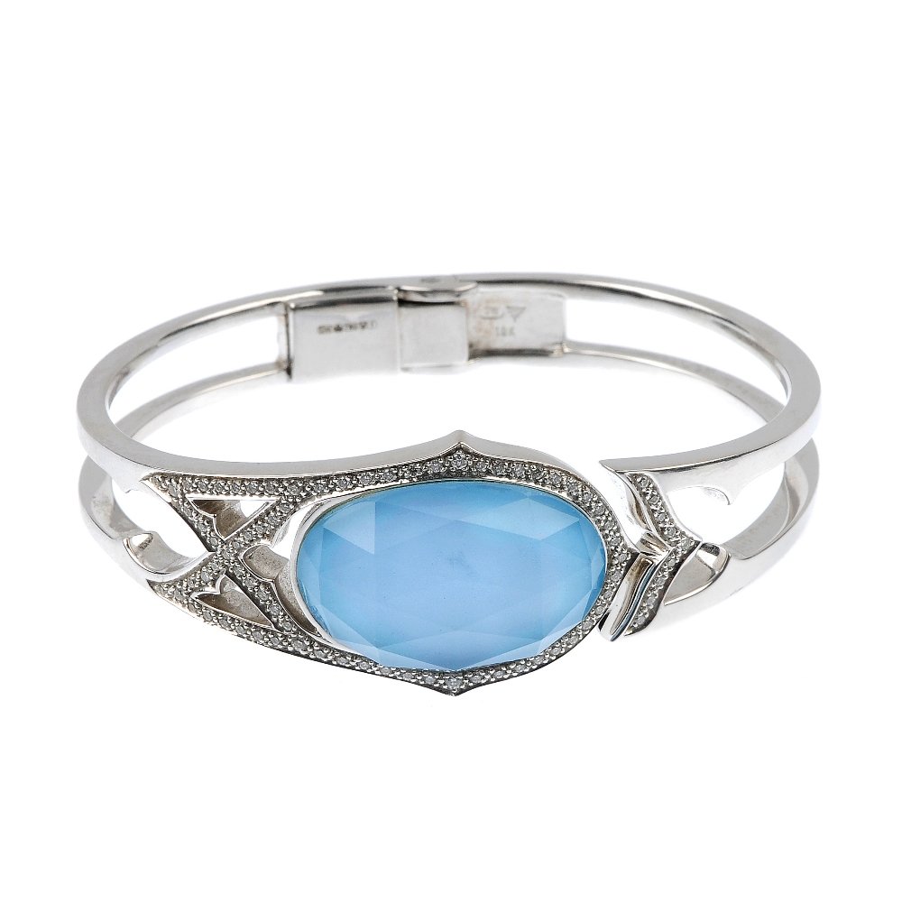 STEPHEN WEBSTER - an 18ct gold turquoise, rock crystal : STEPHEN WEBSTER - an 18ct gold turquoise, rock crystal and diamond 'crystal haze' hinged cuff. The front designed as a turquoise panel, with faceted rock crystal top, within a pave-set diamond surroun