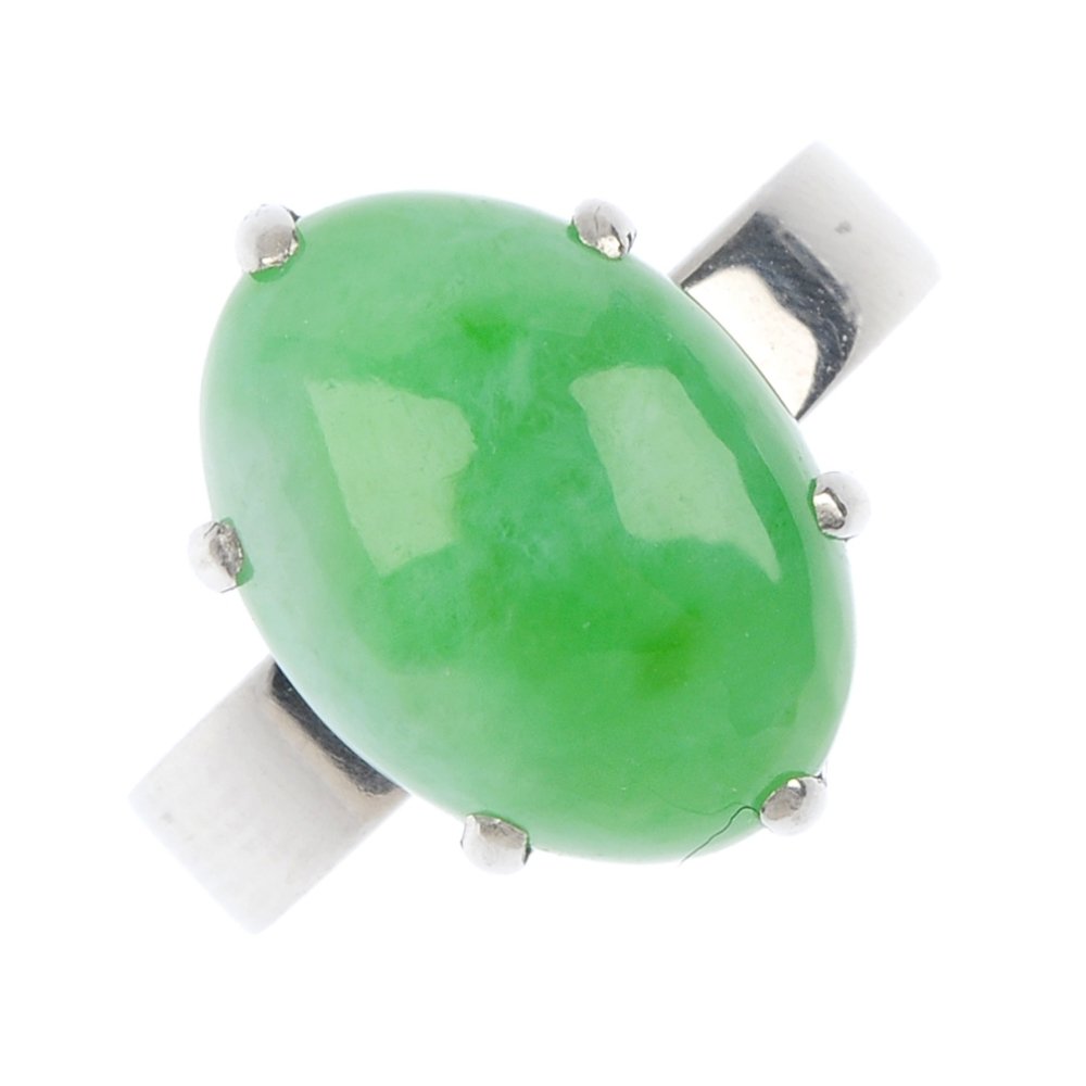 A jade single-stone ring.: A jade single-stone ring. The marquise-shape jadeite cabochon, to the tapered shoulders and plain band. Accompanied by report no 08321, dated 9th August 2013, from The Gem and Pearl Laboratory, statin