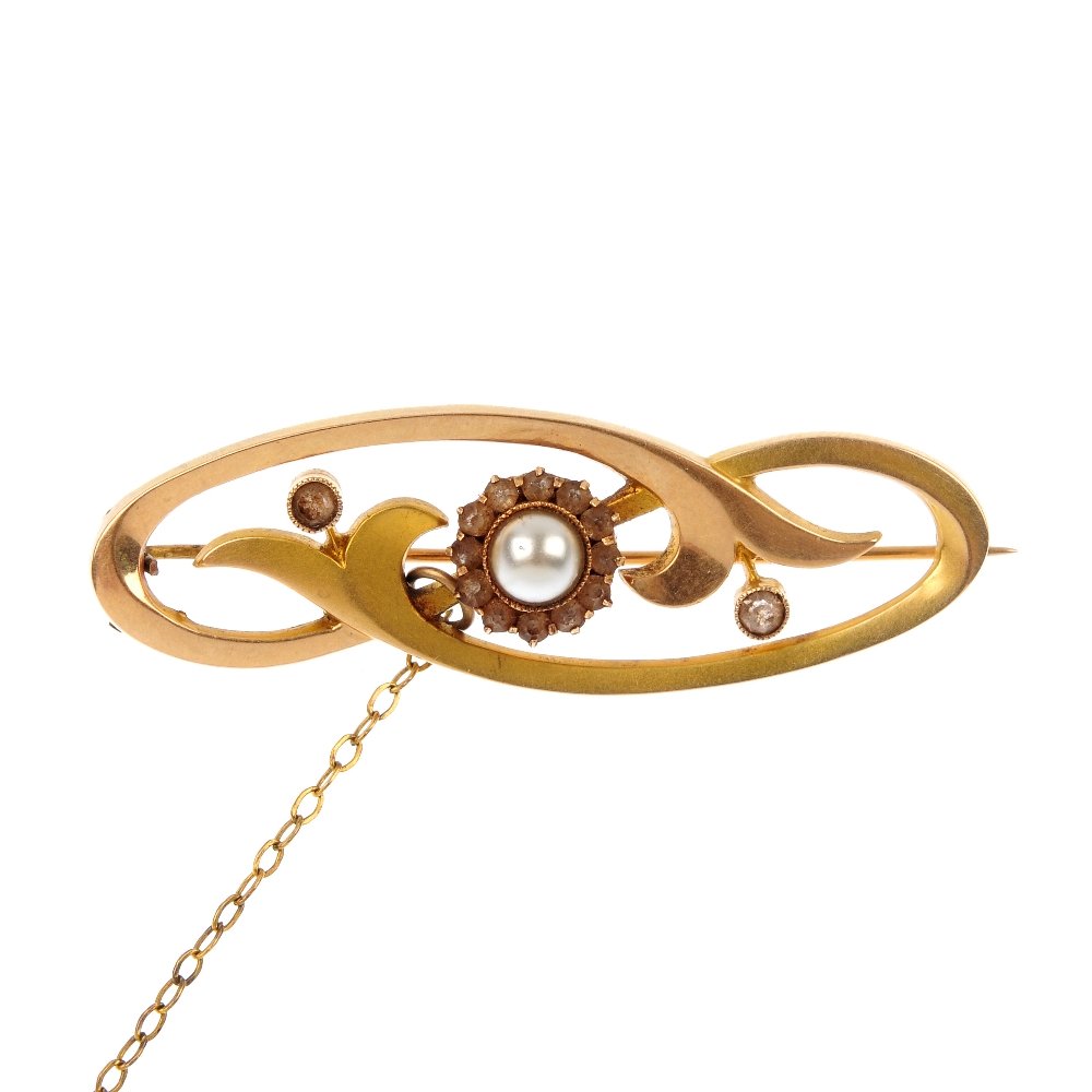An early 20th century 18ct gold imitation pearl and pas: An early 20th century 18ct gold imitation pearl and paste brooch. The imitation pearl and circular-shape colourless paste cluster, within a stylised floral surround. Length 4.6cms. Weight 4.3gms.