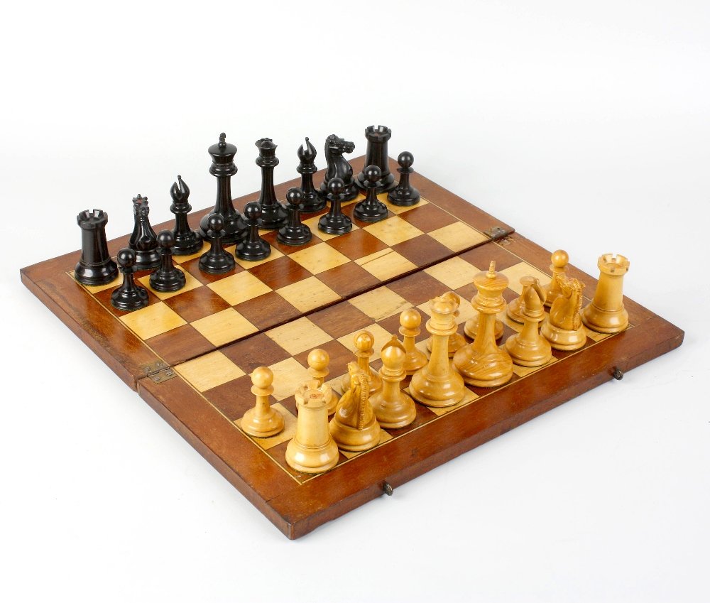 A Jacques Stauton 'Tornament' chess set: A Jacques Staunton 'Tournament' chess set, comprising sixteen boxwood pieces and sixteen ebony, one rook and one knight of each colour impressed with red crown motif, all pieces weighted, kings 3.5" (
