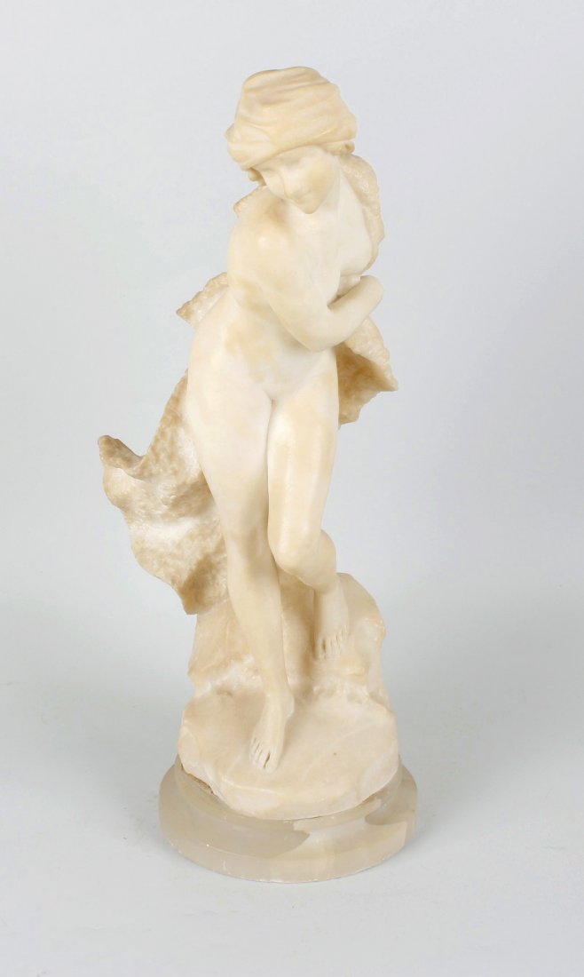 A late 19th century carved Carrara marble figure: A late 19th century carved Carrara marble figure, A. del Perugia, circa 1890, modelled as a naked female with head scarf and billowing cloak, standing on a rocky base, incised signature, raised upon a