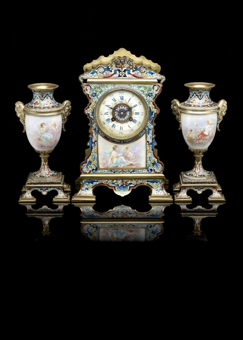 A fine late 19th century French three-piece: A fine 19th century French champleve enamel and porcelain clock garniture. The movement by Louis Boname, Selencourt, Doubs, the porcelain decorated by Collot, Paris. The clock having a 3.75" (9.5cm) c