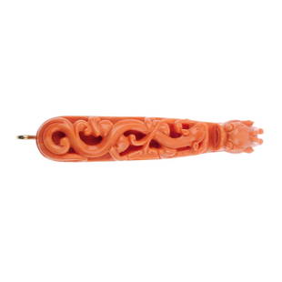 A mid 20th century 18ct gold carved coral Mandarin belt: A mid 20th century 18ct gold carved coral Mandarin belt buckle. The coral carved to depict a weasel gripping a peach tree, to the tapered panel with dragon head terminal and gold fittings. Length 10.2