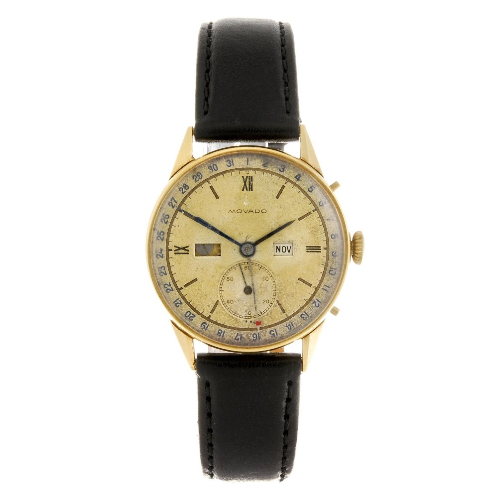 An 18k gold manual wind gentleman's Movado triple: MOVADO - an 18k gold manual wind gentleman's triple calendar wrist watch, the discoloured silvered dial with hourly applied markers, quarterly applied Roman numerals, bordered by a minute track, subsi
