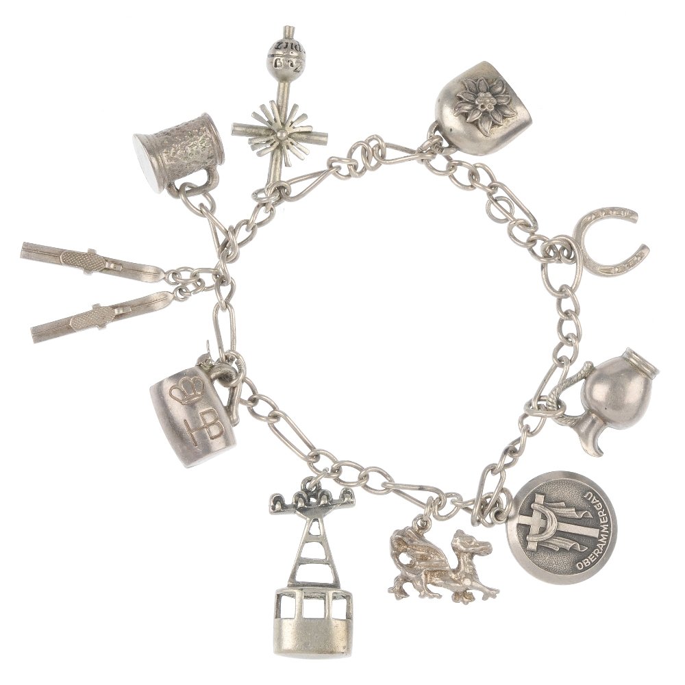 Five charm bracelets.: Five silver and white metal charm bracelets, the curb or belcher-link bracelets suspending a total of forty-seven charms and various enamel town shields, charms to include a cottage and a pair of ski'