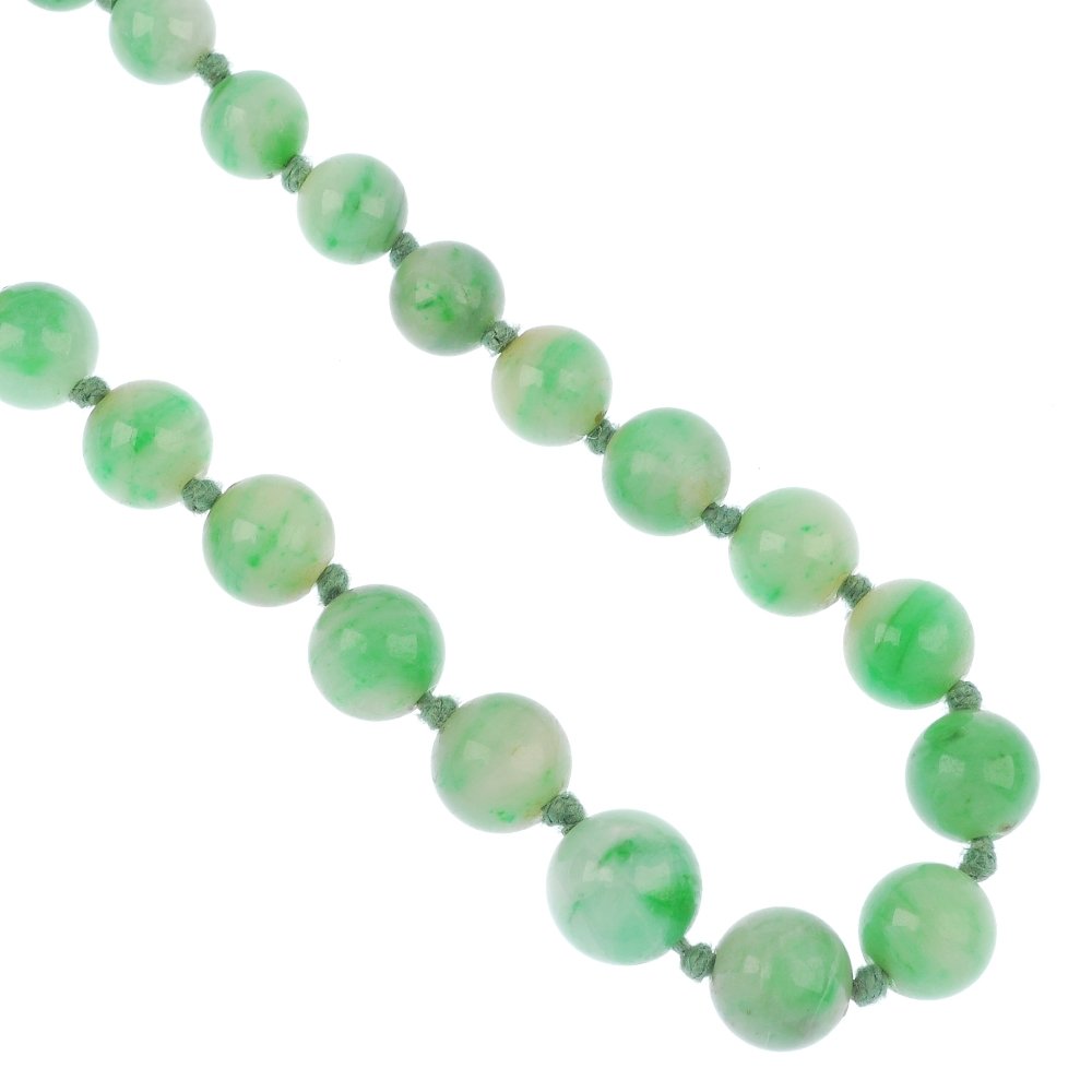 A jade single-strand necklace.: A jade single-strand necklace, comprising a graduated series of seventy-seven jadeite beads, measuring from 9 to 3.8mms, to the base metal spring-ring clasp. Untested for natural colour. Length 58cms.