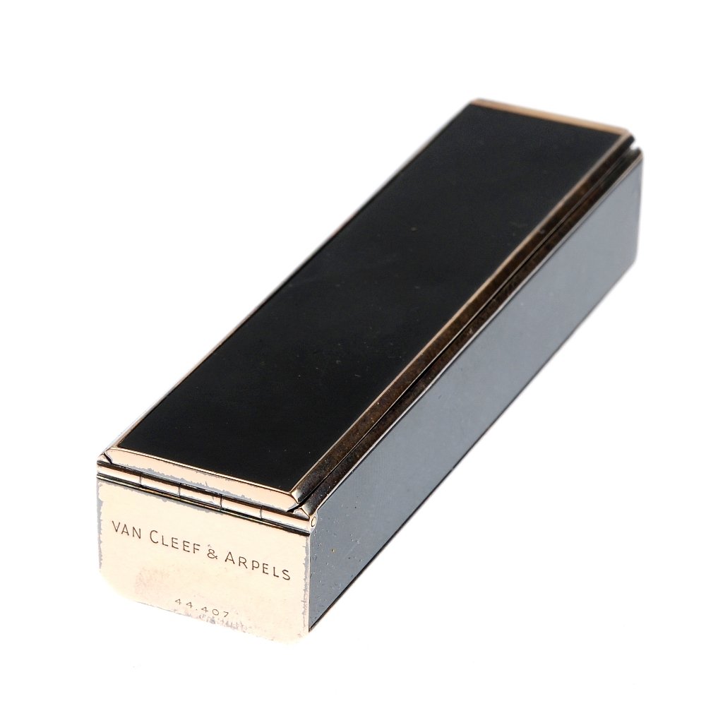 VAN CLEEF & ARPELS - an early 20th century silver gilt: VAN CLEEF & ARPELS - a mid 20th century silver gilt and black plastic vanity case with hinged lid. Stamped Van Cleef & Arpels 44.407. Measuring 6.8 by 1.7 by 1.4cms.
