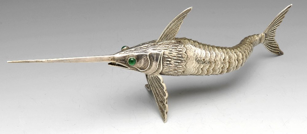A Spanish articulated figure modelled as a swordfish.: A Spanish model of a swordfish with green paste set eyes and realistically moulded and decorated scale detailing with an articulated tail. Struck to one of the fins with the Spanish Pentagram mark alo