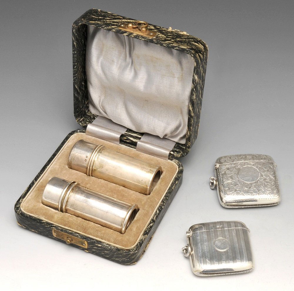 Two early twentieth century silver vesta cases and a: Two early twentieth century silver vesta cases of shaped oblong form, the first with scroll engraving and a vacant circular cartouche, hallmarked John Rose, Birmingham 1913, the second with vertical r