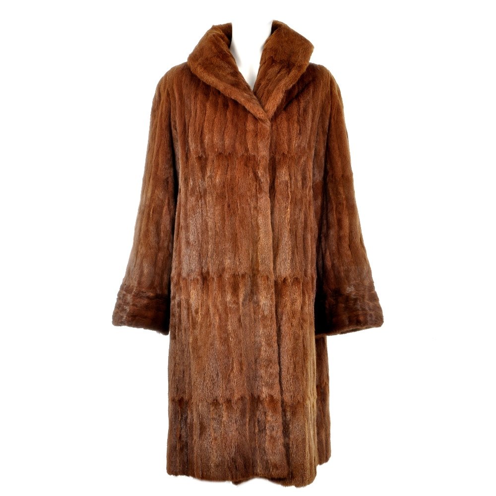 An ermine fur coat.: A dyed, ermine, knee-length fur coat, with lapel collar, wide cocktail cuffs, hook and eye fastenings, two outer pockets and inner ribbon tie. Labelled Creamer's Birmingham. Believed to be a size 16.