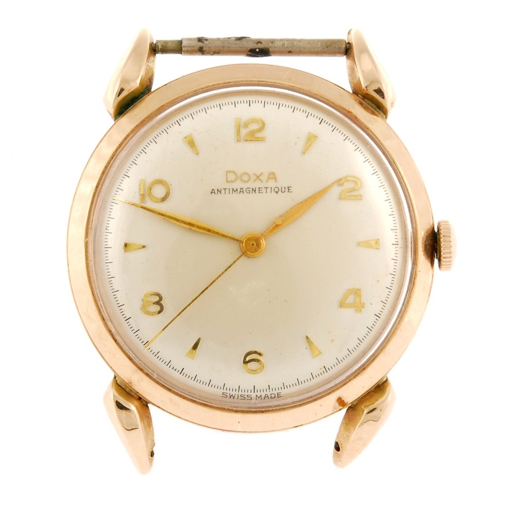 (134181893) A 14k gold manual wind gentleman's Doxa: (134181893) A 14k gold manual wind gentleman's Doxa watch head, the silvered dial with hourly applied Arabic numerals interspaced with markers, round case stamped 0.585, signed movement. Case diameter