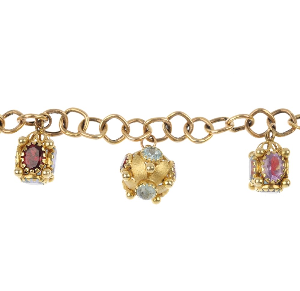 A charm bracelet.: A charm bracelet. Comprising five multi-gem and paste charms, suspended from a fancy-link chain with spring-ring clasp. Length 18.5cms. Weight 20gms.