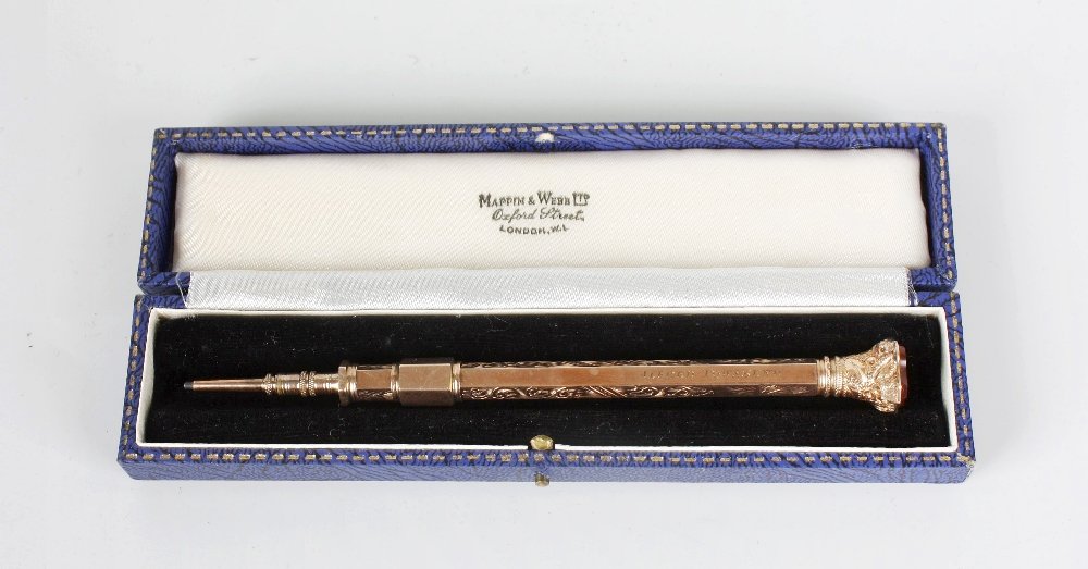 A late Victorian 9ct yellow metal retractable pencil: A late Victorian 9ct yellow metal retractable pencil, with shield shaped carnelian seal terminal, the foliage engraved, hexagonal barrel stamped EB 9CT, 4.1" (10.5cm) closed, in associated case.