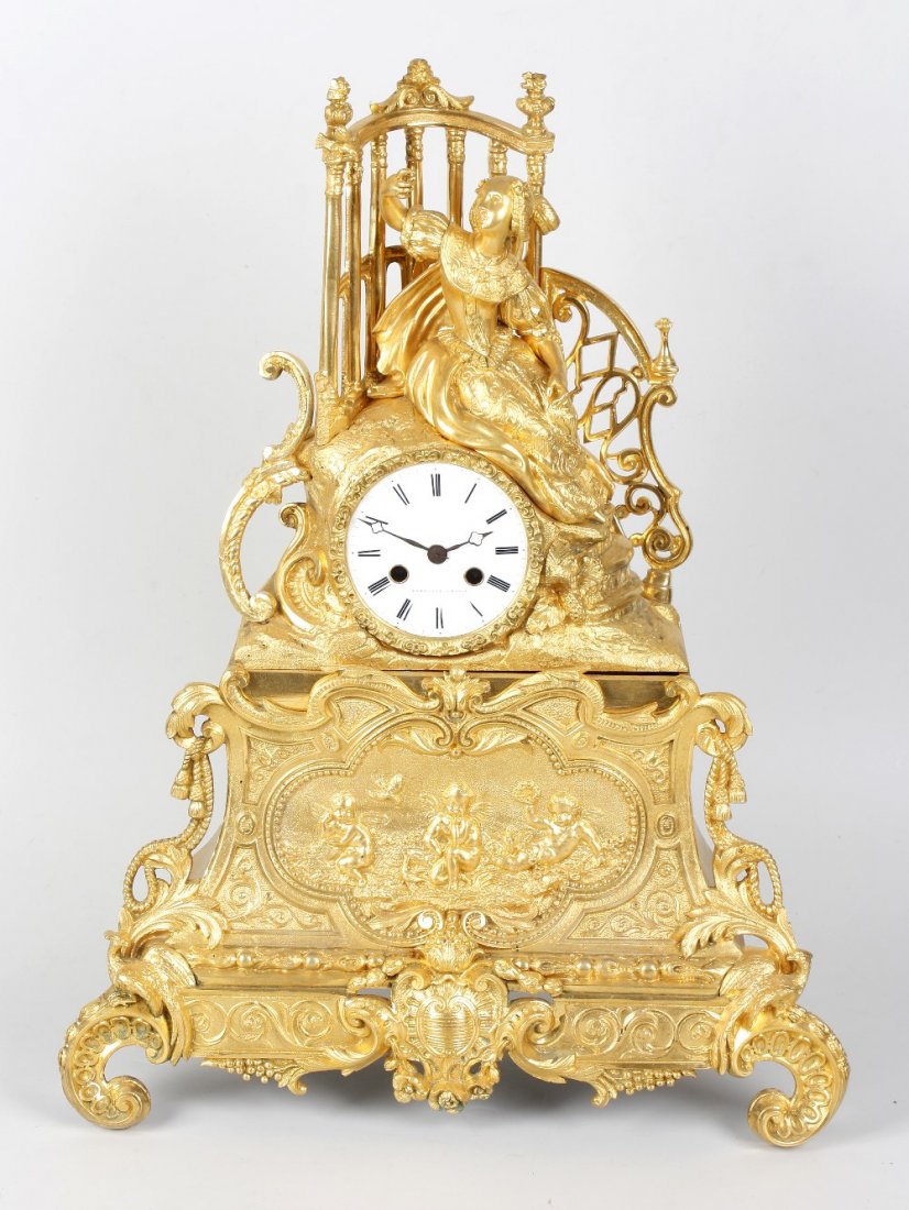 A mid 19th century French gilt brass and ormolu mantle : A mid 19th century French gilt brass and ormolu mantel clock, Cailly, St. Nicholas, retailed by Rateliff, Paris, the 3.25-inch white Roman dial inscribed 'RATELIFF A PARIS' with quatrefoil hands, the