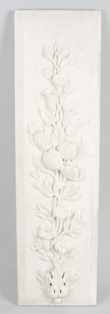 A pair of carved alabaster relief panels: A pair of carved alabaster relief panels, probably removed from a fireplace, each modelled with a flowering plant, 7.75" x 28.5" (19.5cm x 72.5cm).