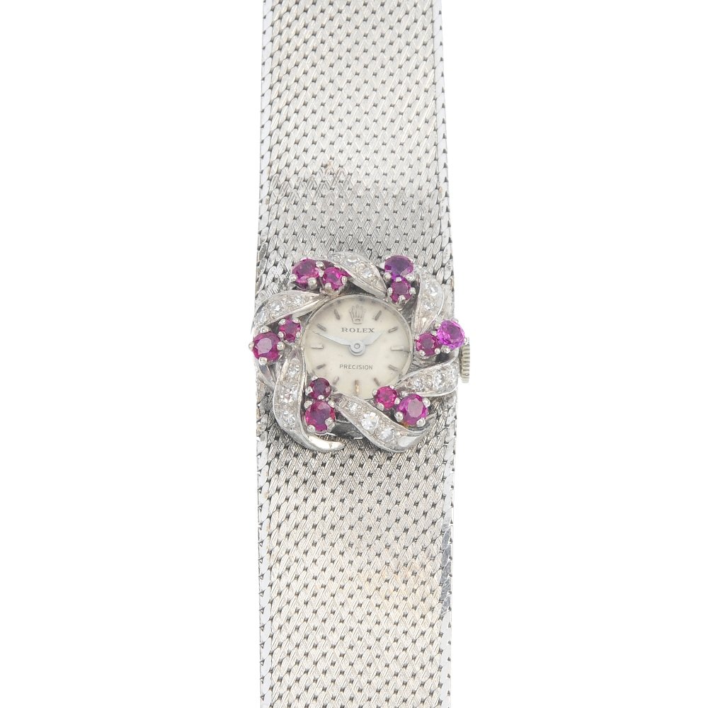 ROLEX - a ruby and diamond manual wind cocktail watch.: ROLEX - a ruby and diamond manual wind cocktail watch. The circular cream dial, with baton hourly markers, within a circular-shape ruby and single-cut diamond stylised wreath surround, to the textured