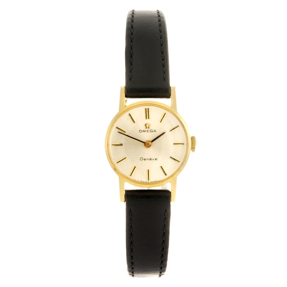An 18k gold manual wind lady's Omega Geneve wrist watch: OMEGA - an 18k gold manual wind lady's Geneve wrist watch, the silvered dial with hourly applied batons, round case stamped 18K 0.750 with poincon, fitted to a non-original black leather strap with pi