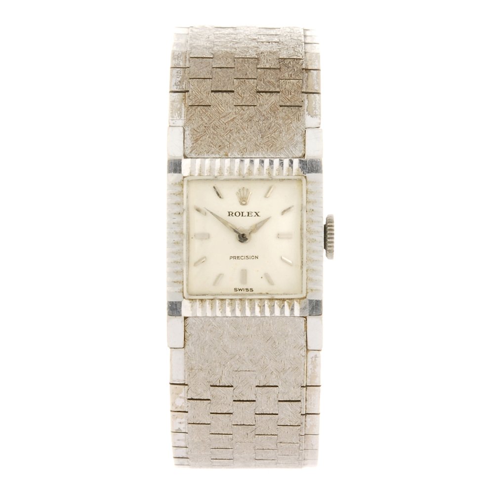 An 18k white gold manual wind lady's Rolex Precision: ROLEX - an 18k white gold manual wind lady's Precision bracelet watch, the silvered dial with hourly applied markers, square case stamped 0.750 18K with poincon, numbered 809636, fitted to an 18k whit