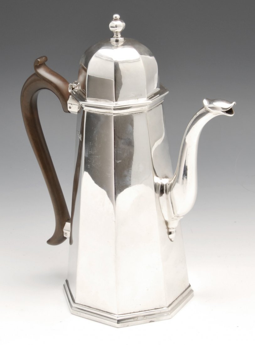 An Edwardian silver coffee pot.: An Edwardian silver coffee pot of tapered octagonal form and domed hinged lid with conforming finial. Hallmarked Charles Stuart Harris, London 1904. Height measuring 10 inches (25 cm), weight 24 ozt (