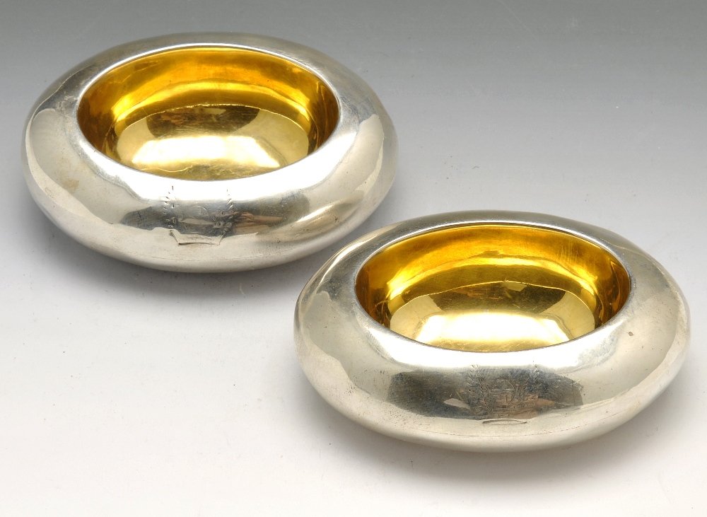 A Victorian pair of silver open salts.: A Victorian pair of silver open salts of oval hollow pebble form with silver-gilt interiors, crested. Hallmarked London 1874, the maker's mark S.V and also marked Widdowson & Vale, 73 Strand. Maximum