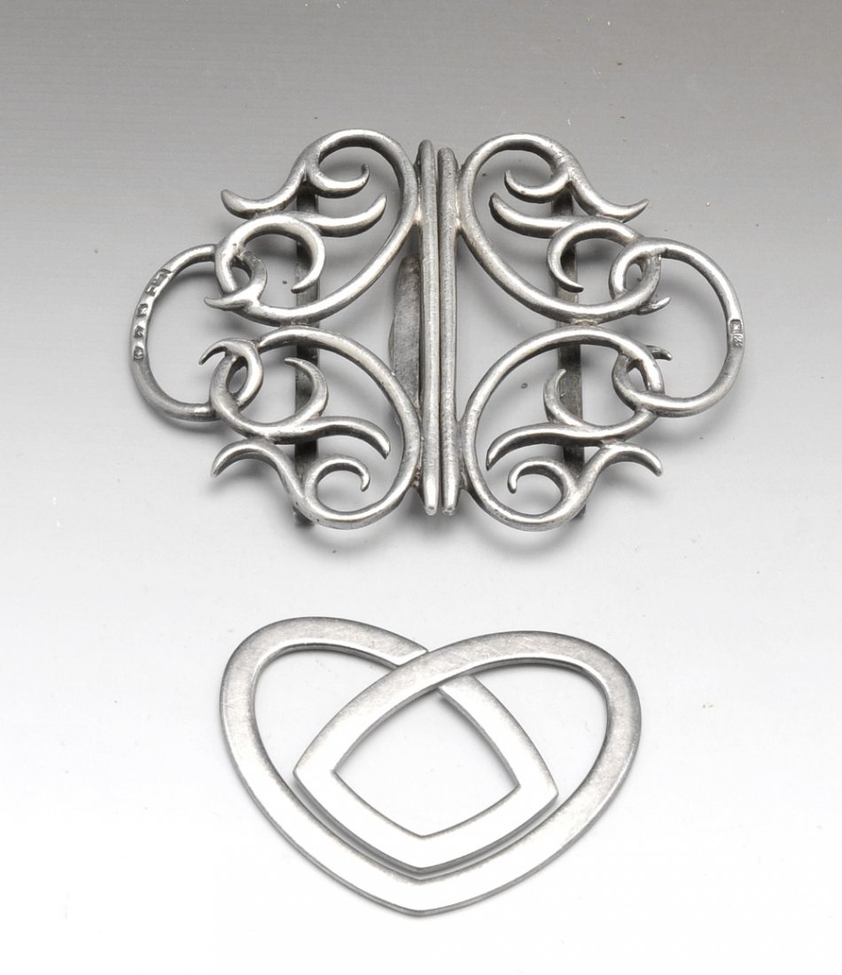 A late Victorian silver belt buckle and a bookmark.: A late Victorian silver belt buckle, of wire open-work scroll design, hallmarked Lawrence Emanuel, Birmingham 1899, together with a silver bookmark designed as an Art Nouveau style heart, stamped '925