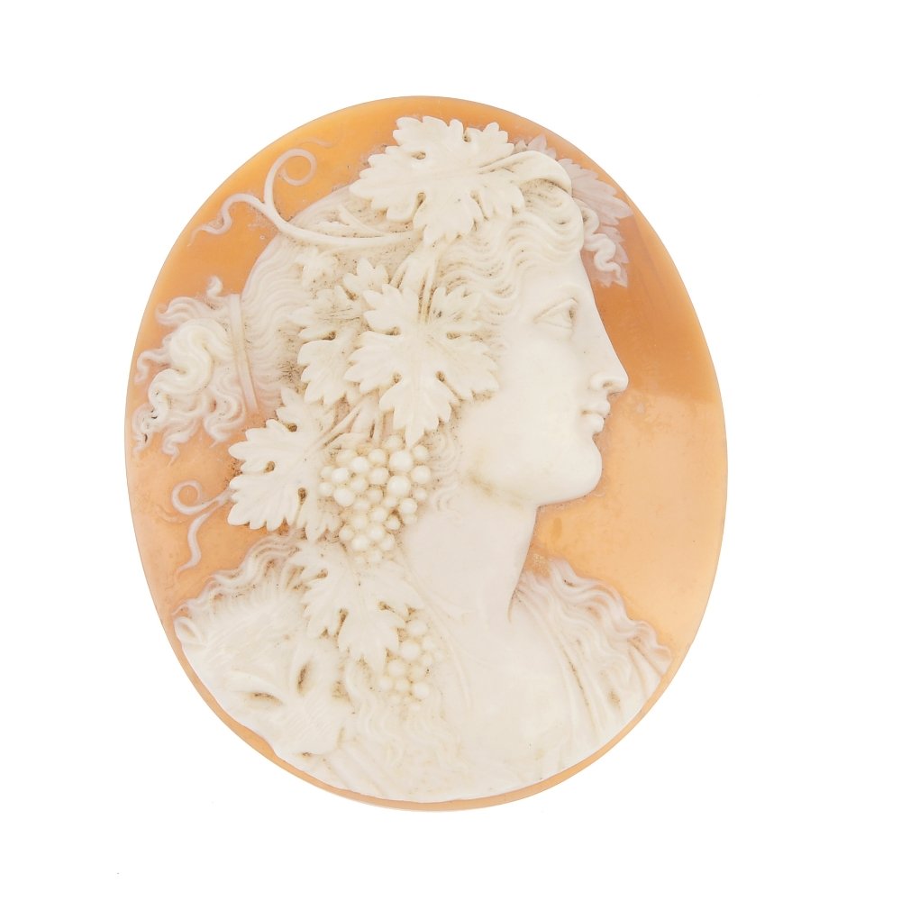 A late 19th century shell cameo.: A late 19th century shell cameo, carved to depict a bacchante, with animal pelt and grape and vine detail. Length 5.6cms.