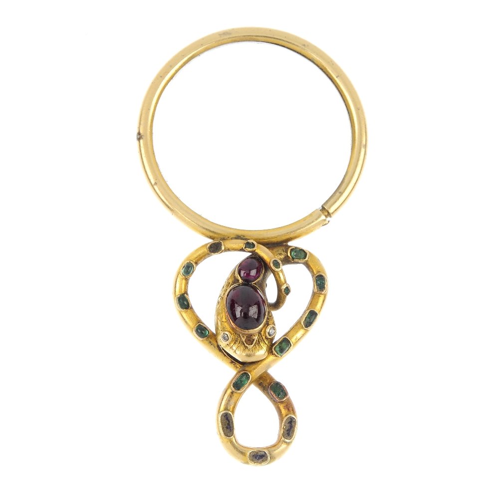 A mid Victorian gold gem-set magnifying glass, circa: A mid Victorian gold gem-set magnifying glass, circa 1860, the circular-shape magnifying glass, to the interwoven serpent surmount set with foil-back green gems, oval garnet cabochons and rose-cut eye