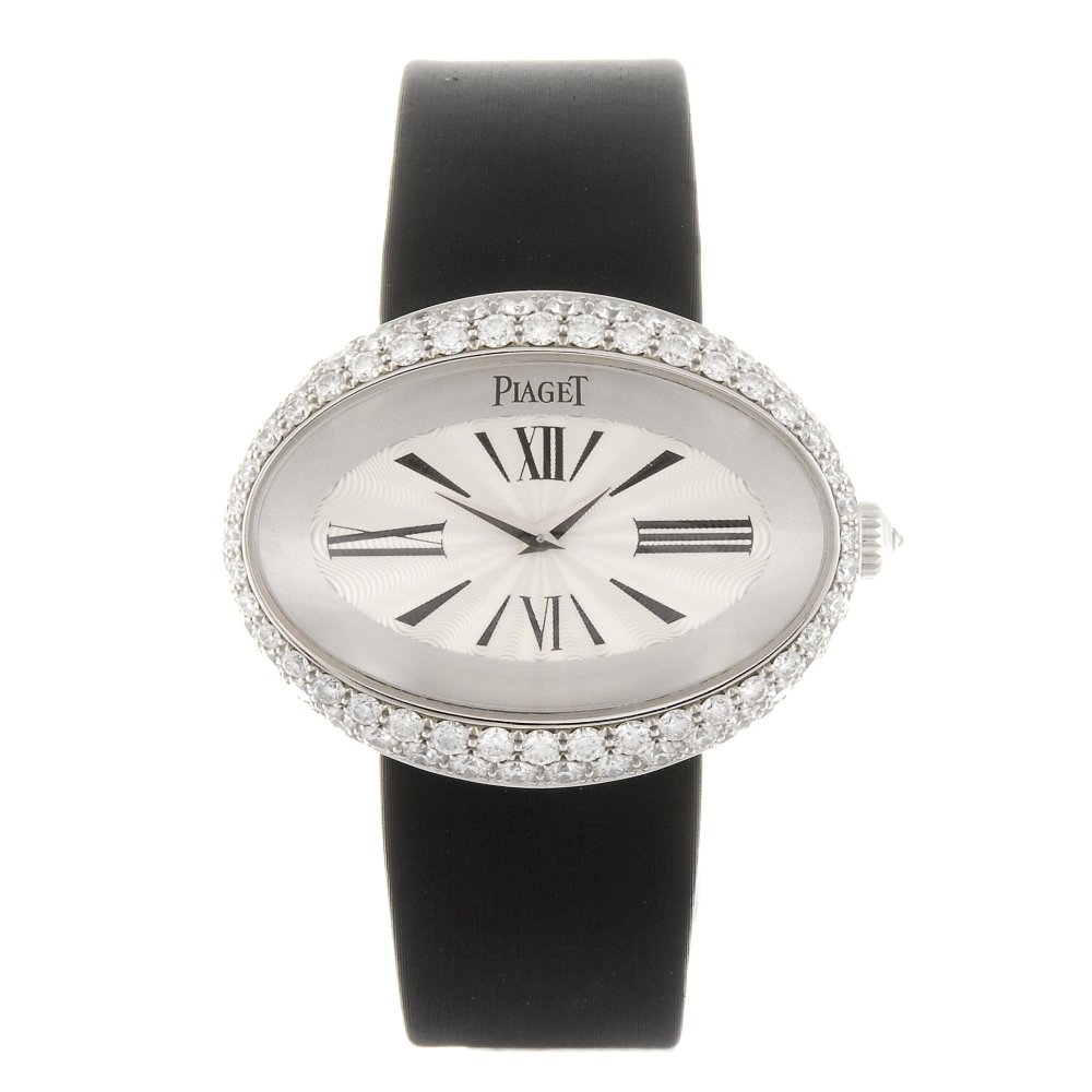 PIAGET - a lady's Limelight wrist watch.: PIAGET - a lady's Limelight wrist watch. Number P10375 and 954334. Manual wind movement. Silvered dial with hour markers, quarterly Arabic numerals. 18ct white gold diamond set case fitted to an authe