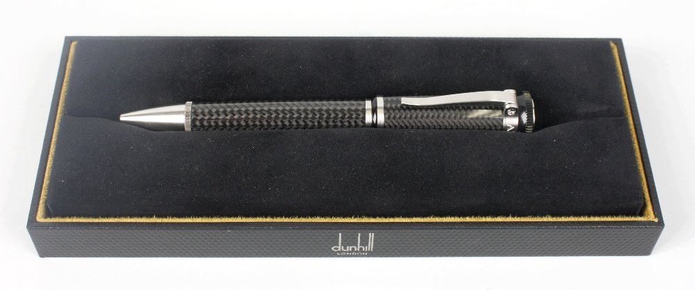 A Dunhill Sentryman rollerball pen: A Dunhill Sentryman rollerball pen, with carbon fibre weave body and brushed steel clip and banding, stamped 'Alfred Dunhill' to top with monogram, 5.5" (14cm) long, in maker's box/display case.