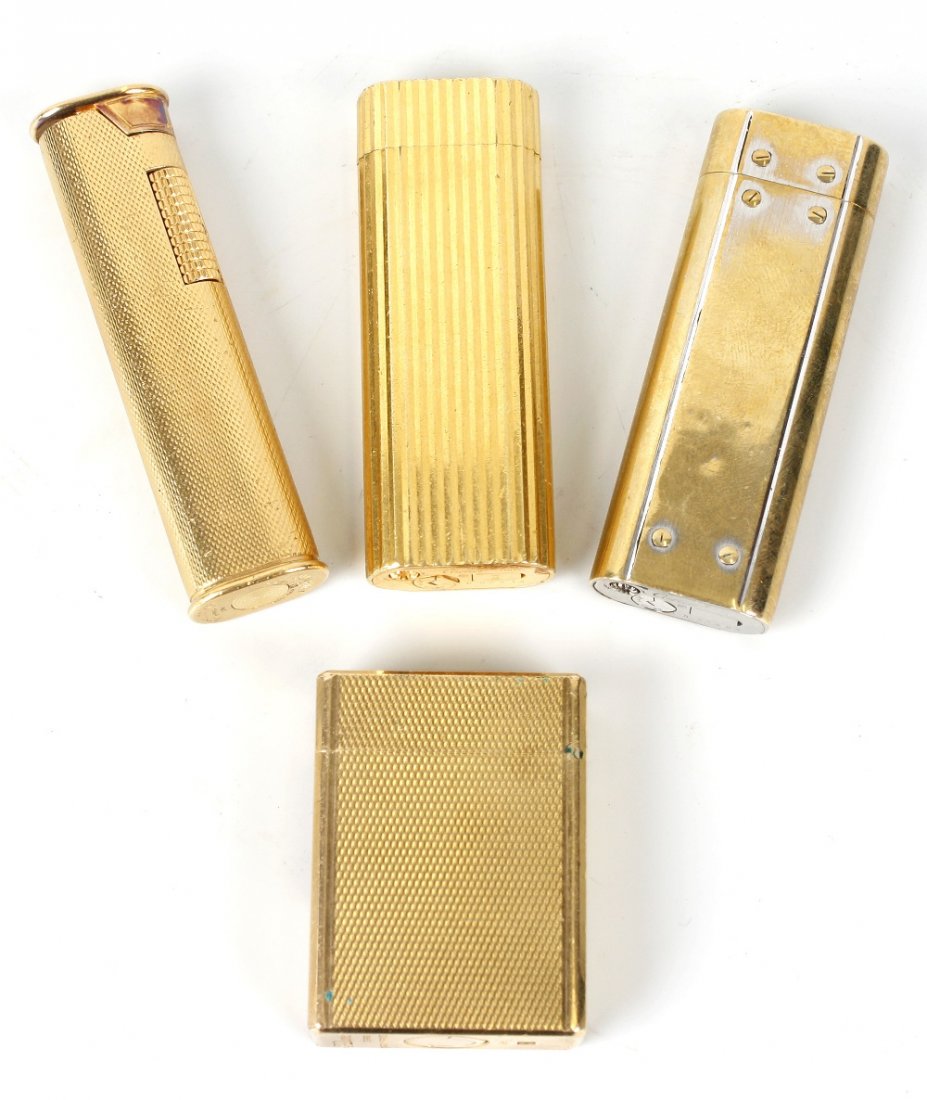 Four assorted cigarette lighters: Four assorted cigarette lighters. Comprising: two by Cartier, one with ribbed finish, numbered C02214, the other plain, N29657; a Dupont example with textured finish, C4BU38, and a Dunhill example wit