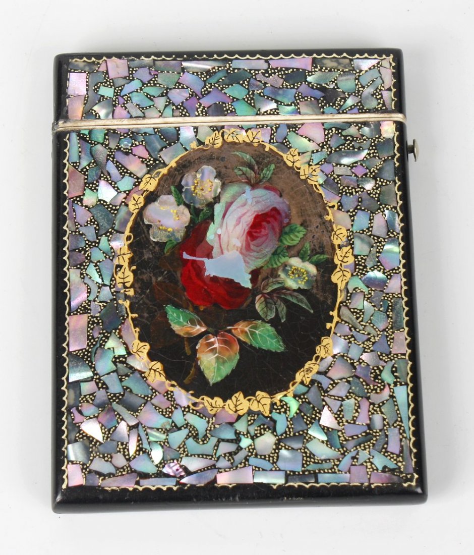 A Victorian black lacquered papier mache and mother of : A Victorian black lacquered papier mache and mother of pearl visiting card case, the rectangular body inlaid to each face with an oval floral panel within gilt enriched shards, 3.25" x 4.25" (8cm x 11