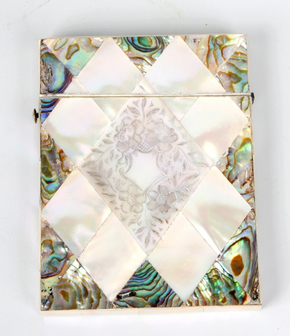 A mother of pearl and abalone shell visiting card case: A mother of pearl and abalone shell visiting card case, each face decorated with lozenge-shaped panels, one side centred by a large flower-incised panel, both face bordered in abalone shell, 3" x 4" (